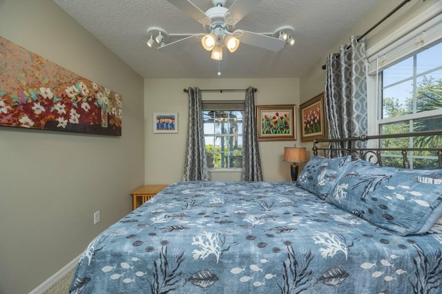 232 Riberia St, Saint Augustine, FL 32084 - bedroom featuring ceiling fan, a textured ceiling, carpet flooring, and baseboards