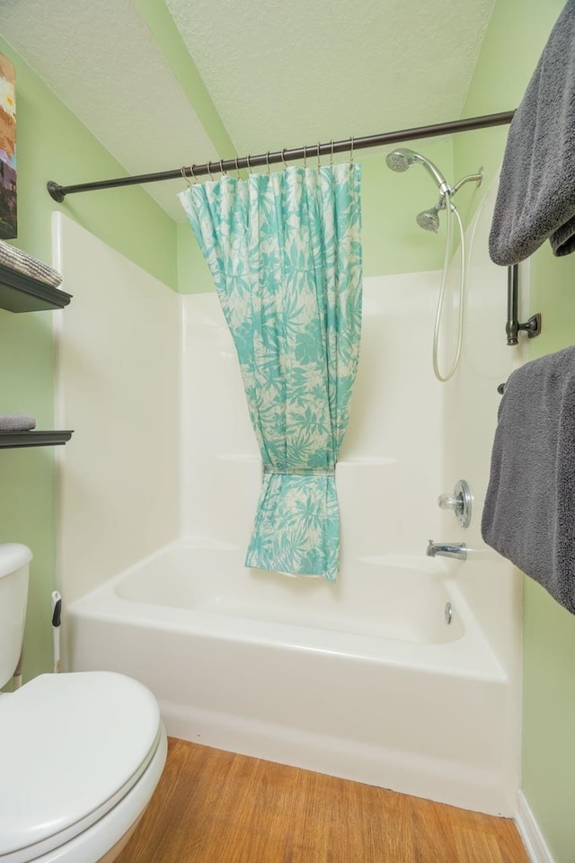 232 Riberia St, Saint Augustine, FL 32084 - bathroom with toilet, shower / bath combo with shower curtain, and wood finished floors