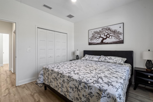 bedroom featuring wood-type flooring and a closet