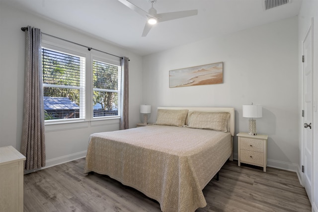 bedroom with hardwood / wood-style floors and ceiling fan