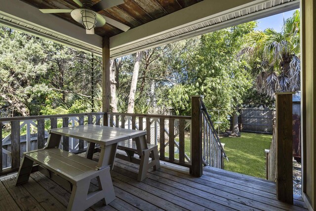 deck with a lawn and ceiling fan