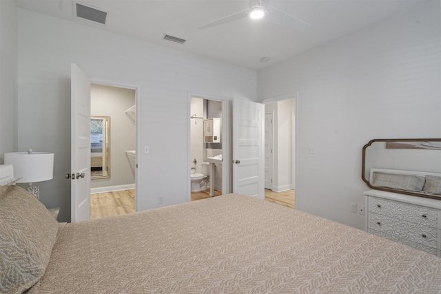 bedroom featuring ensuite bath, ceiling fan, and light hardwood / wood-style flooring