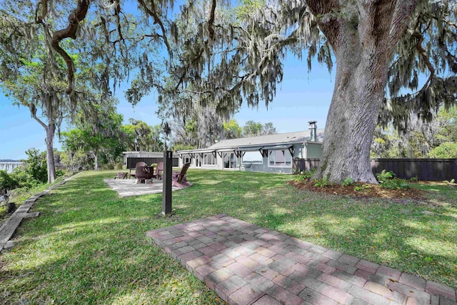 view of yard with a patio and fence