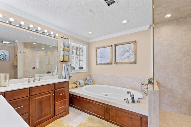 bathroom with a textured ceiling, crown molding, tile patterned floors, a walk in shower, and a whirlpool tub