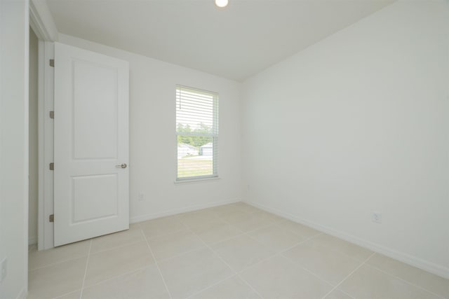 166 Fairlake Cir, Saint Augustine, FL 32092 - empty room with light tile patterned flooring and baseboards