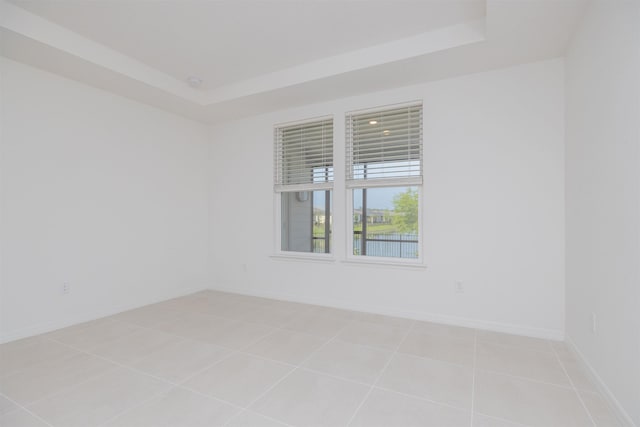 166 Fairlake Cir, Saint Augustine, FL 32092 - unfurnished room with a raised ceiling, light tile patterned floors, and baseboards