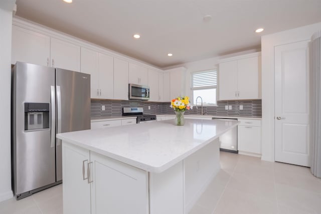166 Fairlake Cir, Saint Augustine, FL 32092 - kitchen featuring stainless steel appliances, white cabinets, a center island, tasteful backsplash, and recessed lighting