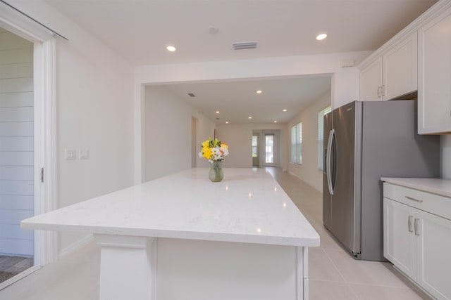 166 Fairlake Cir, Saint Augustine, FL 32092 - kitchen with white cabinetry, stainless steel refrigerator with ice dispenser, a center island, recessed lighting, and light stone countertops