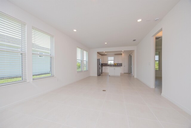 166 Fairlake Cir, Saint Augustine, FL 32092 - unfurnished living room with recessed lighting, light tile patterned floors, and baseboards