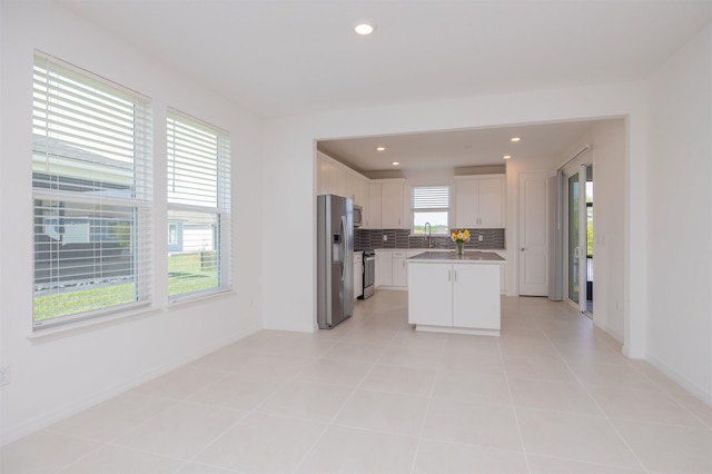166 Fairlake Cir, Saint Augustine, FL 32092 - kitchen featuring appliances with stainless steel finishes, tasteful backsplash, white cabinets, a sink, and recessed lighting