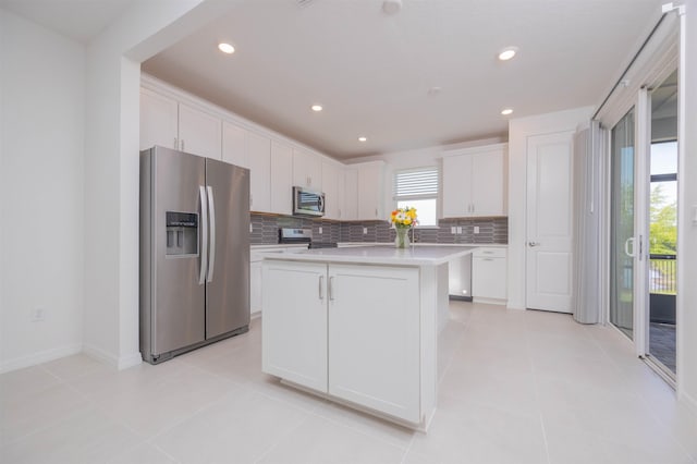 166 Fairlake Cir, Saint Augustine, FL 32092 - kitchen with stainless steel appliances, tasteful backsplash, white cabinetry, light countertops, and recessed lighting
