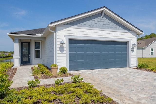 166 Fairlake Cir, Saint Augustine, FL 32092 - ranch-style home featuring a garage, decorative driveway, and a shingled roof