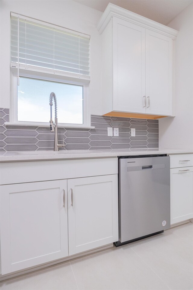 166 Fairlake Cir, Saint Augustine, FL 32092 - kitchen featuring stainless steel dishwasher, white cabinetry, light countertops, decorative backsplash, and a sink