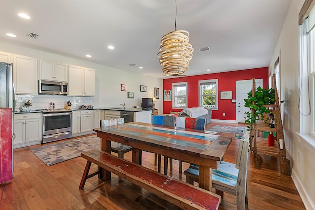 161 Blanco St, Saint Augustine, FL 32084 - dining area featuring a notable chandelier, recessed lighting, visible vents, wood finished floors, and baseboards