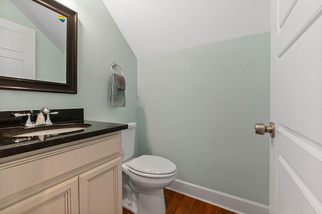 161 Blanco St, Saint Augustine, FL 32084 - bathroom featuring toilet, vaulted ceiling, vanity, wood finished floors, and baseboards