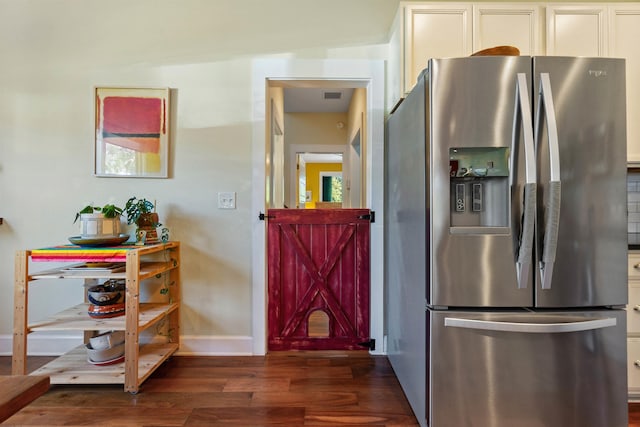 161 Blanco St, Saint Augustine, FL 32084 - kitchen with baseboards, visible vents, dark wood finished floors, stainless steel fridge with ice dispenser, and white cabinetry