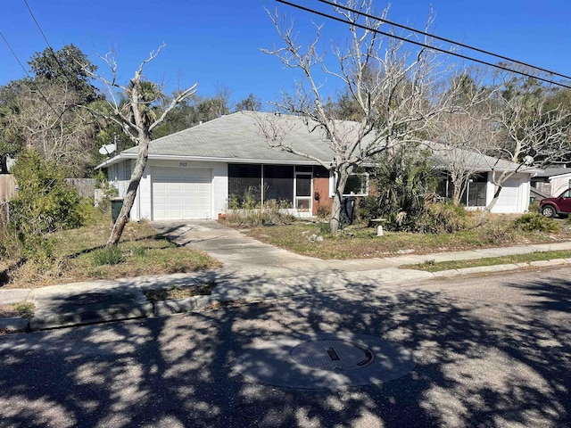 ranch-style home with driveway and an attached garage