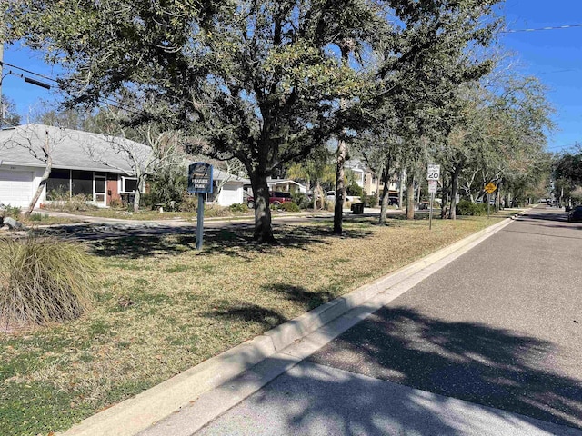 view of road featuring traffic signs and curbs