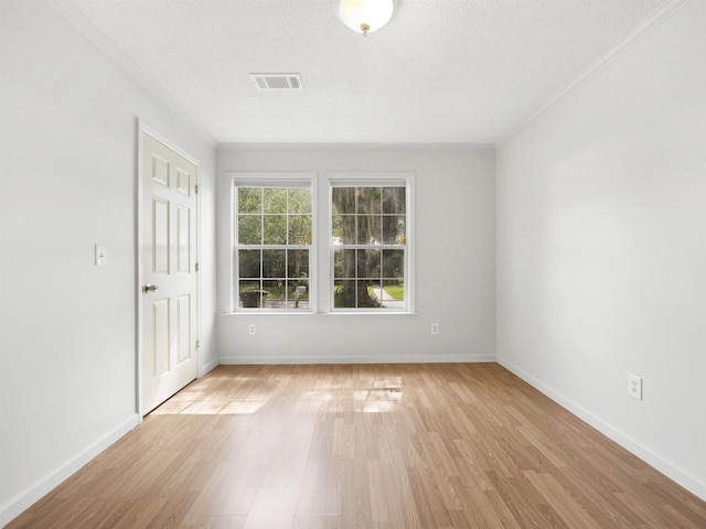 50 Spring St, Saint Augustine, FL 32084 - empty room with ornamental molding, light wood-type flooring, and a textured ceiling