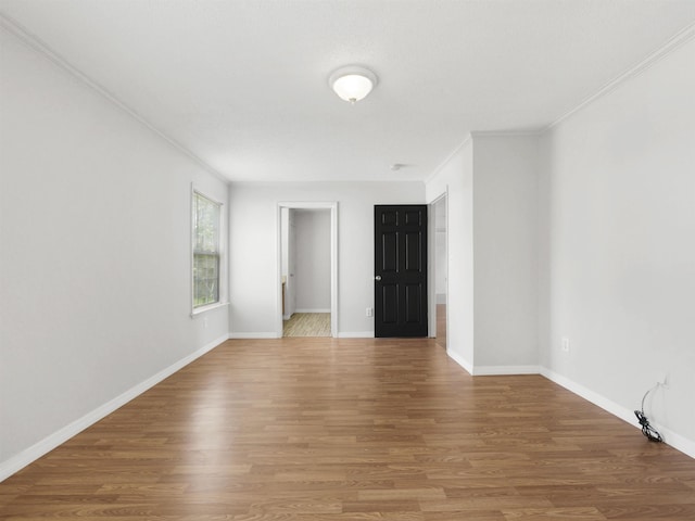 50 Spring St, Saint Augustine, FL 32084 - spare room featuring wood finished floors and ornamental molding