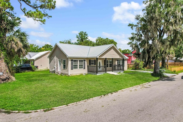 50 Spring St, Saint Augustine, FL 32084 - ranch-style home with covered porch, a front lawn, and a metal roof