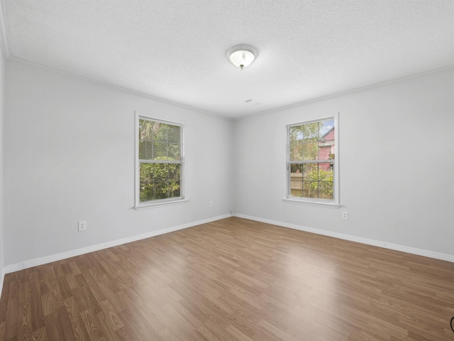 50 Spring St, Saint Augustine, FL 32084 - unfurnished room featuring wood finished floors, a textured ceiling, and ornamental molding