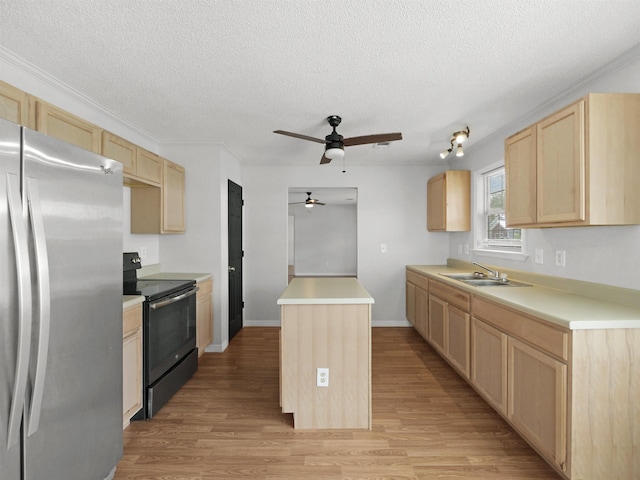50 Spring St, Saint Augustine, FL 32084 - kitchen with freestanding refrigerator, range with electric stovetop, light brown cabinetry, ceiling fan, and a center island
