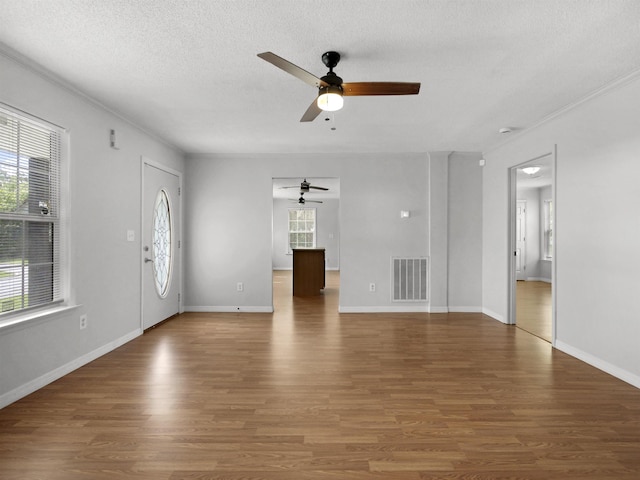 50 Spring St, Saint Augustine, FL 32084 - unfurnished living room with a ceiling fan, wood finished floors, a textured ceiling, and ornamental molding