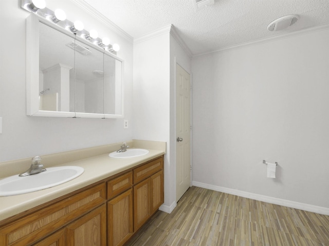 50 Spring St, Saint Augustine, FL 32084 - full bath featuring double vanity, wood finished floors, a textured ceiling, and ornamental molding