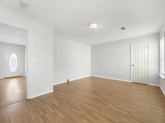 50 Spring St, Saint Augustine, FL 32084 - empty room with a smoke detector, light wood-style floors, and ornamental molding