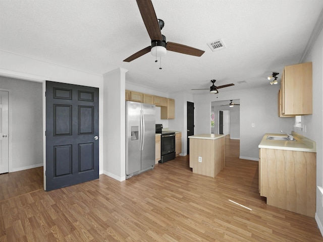 50 Spring St, Saint Augustine, FL 32084 - kitchen with black / electric stove, stainless steel fridge, ceiling fan, light brown cabinetry, and a kitchen island