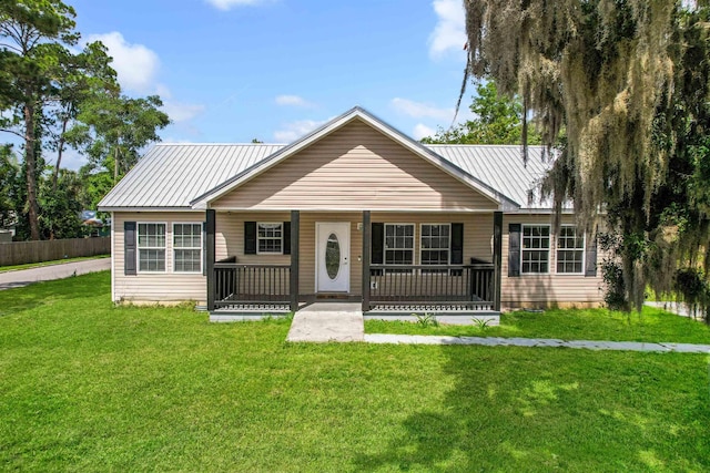 50 Spring St, Saint Augustine, FL 32084 - ranch-style house featuring covered porch, a front yard, and a metal roof