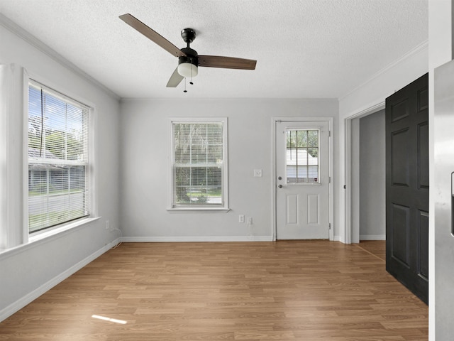 50 Spring St, Saint Augustine, FL 32084 - entrance foyer featuring ceiling fan, light wood finished floors, a textured ceiling, and ornamental molding