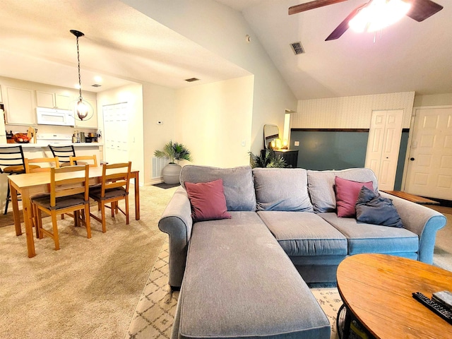 carpeted living room featuring ceiling fan and lofted ceiling