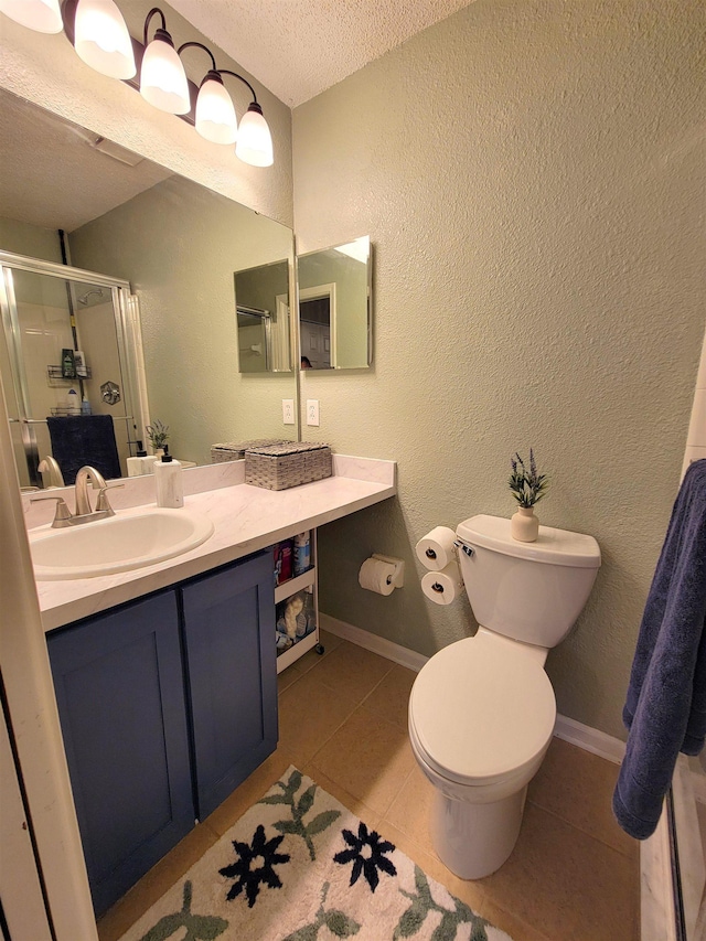 bathroom featuring tile patterned flooring, an enclosed shower, a textured ceiling, toilet, and vanity