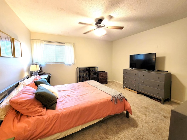 carpeted bedroom with ceiling fan and a textured ceiling