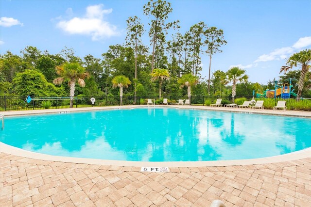 189 Blue Creek Way, Saint Augustine, FL 32086 - community pool with view of wooded area and a patio area