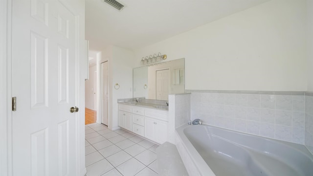 53 Pritchard Dr, Palm Coast, FL 32164 - bathroom with a garden tub, double vanity, and tile patterned flooring