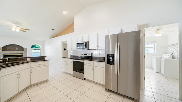 53 Pritchard Dr, Palm Coast, FL 32164 - kitchen featuring appliances with stainless steel finishes, washing machine and dryer, a ceiling fan, dark countertops, and backsplash