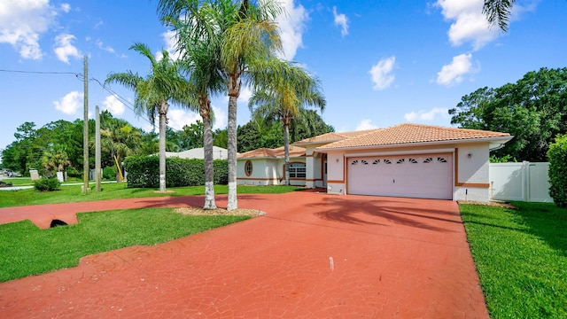 53 Pritchard Dr, Palm Coast, FL 32164 - mediterranean / spanish house featuring a tiled roof, concrete driveway, a garage, stucco siding, and a gate
