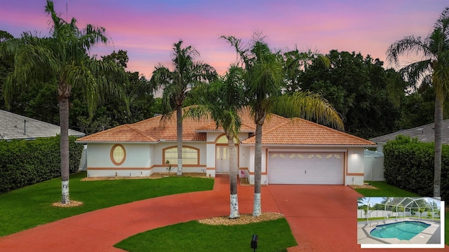 53 Pritchard Dr, Palm Coast, FL 32164 - mediterranean / spanish home featuring concrete driveway, stucco siding, a garage, a front yard, and a tile roof
