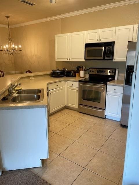 225 Old Village Center Cir Unit 4307, Saint Augustine, FL 32086 - kitchen with stainless steel appliances, a chandelier, white cabinets, crown molding, and light tile patterned floors