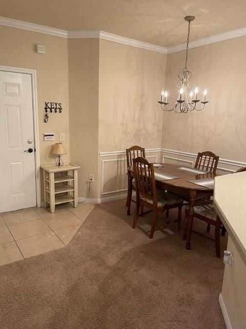225 Old Village Center Cir Unit 4307, Saint Augustine, FL 32086 - dining space featuring crown molding, a chandelier, light tile patterned floors, and light carpet