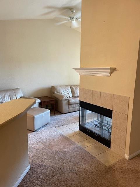 225 Old Village Center Cir Unit 4307, Saint Augustine, FL 32086 - unfurnished living room featuring a ceiling fan, light colored carpet, a tile fireplace, and lofted ceiling