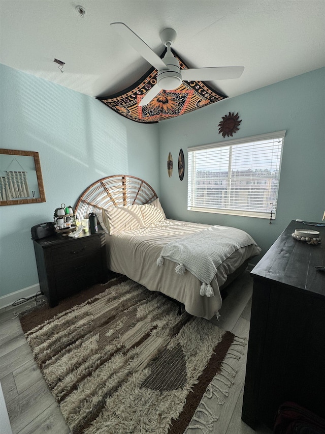 bedroom with hardwood / wood-style flooring and ceiling fan