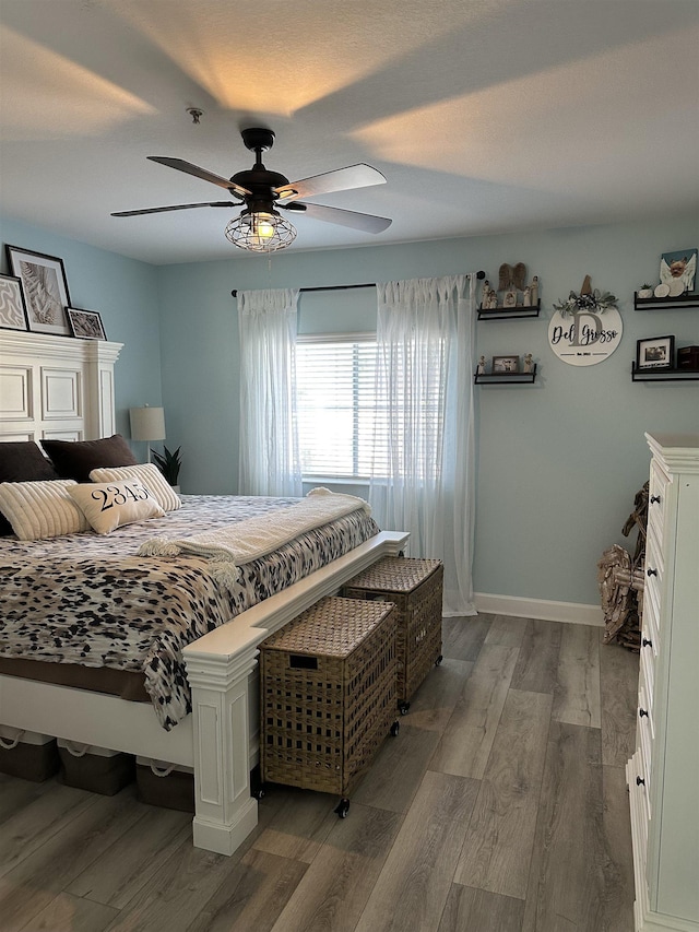 bedroom featuring hardwood / wood-style flooring and ceiling fan