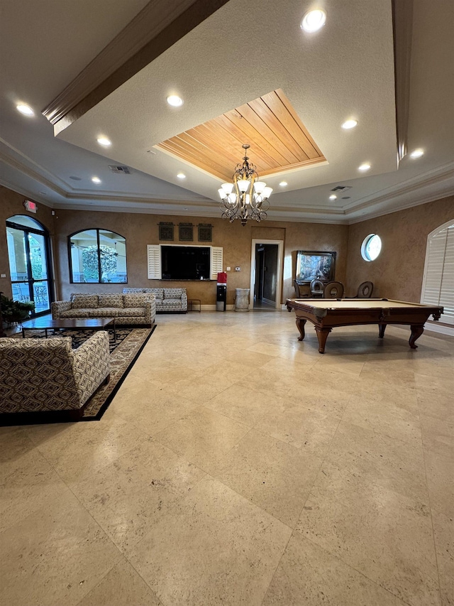 game room with ornamental molding and a tray ceiling