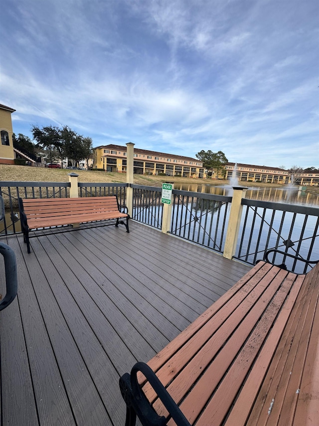 wooden deck featuring a water view