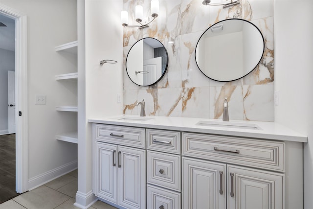 full bath featuring double vanity, backsplash, a sink, and tile patterned floors