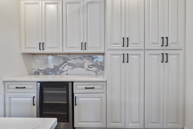 bar featuring tasteful backsplash, wine cooler, and a dry bar